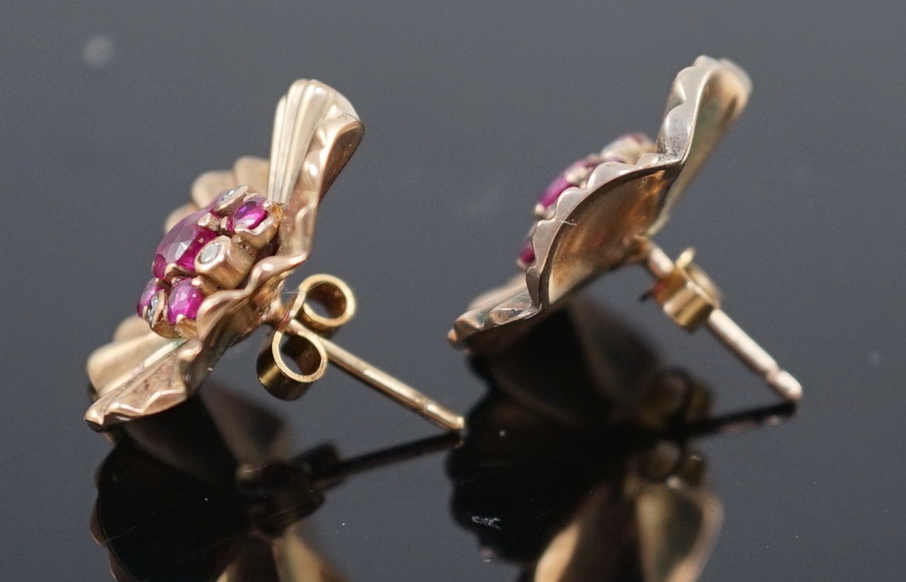 A pair of 1950's gold, ruby and diamond cluster set flower head earrings